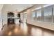 Living Room featuring sleek hardwood floors, large windows, and lots of light at 3130 Hardin St, Castle Rock, CO 80109