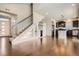 Open-concept living space featuring hardwood floors, staircase, and modern finishes at 3130 Hardin St, Castle Rock, CO 80109