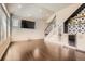 Comfortable living room featuring sleek floors, a TV, and shelving for décor at 3130 Hardin St, Castle Rock, CO 80109