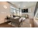 Bright living room with a large window, comfortable seating, and a modern entertainment setup at 3130 Hardin St, Castle Rock, CO 80109