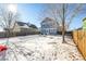 Large backyard with snow, detached garage, and play area at 2728 Renshaw St, Strasburg, CO 80136