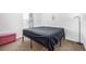 Simple bedroom with a full-size bed and floor lamp at 2728 Renshaw St, Strasburg, CO 80136