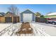 Detached garage with single car door in winter at 2728 Renshaw St, Strasburg, CO 80136