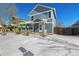 Two-story house with gray siding, covered porch, and snow-covered yard at 2728 Renshaw St, Strasburg, CO 80136