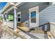 Covered porch with wooden railings and a small table and chairs at 2728 Renshaw St, Strasburg, CO 80136