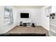 Living room with a sofa, TV, and a window at 2728 Renshaw St, Strasburg, CO 80136