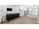 Living room with a sofa, TV, and shelving unit at 2728 Renshaw St, Strasburg, CO 80136