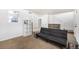 Living room with sofa, shelving, and view of kitchen at 2728 Renshaw St, Strasburg, CO 80136