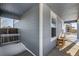 Covered side porch with wooden railings and a small table at 2728 Renshaw St, Strasburg, CO 80136