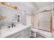 Bathroom featuring updated vanity, faucet, and shower with marble tile at 350 S Clinton St # 8C, Denver, CO 80247