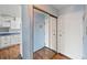 Entryway with a mirrored closet, and view into kitchen at 350 S Clinton St # 8C, Denver, CO 80247