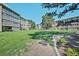 Condo building surrounded by green lawn and mature trees at 350 S Clinton St # 8C, Denver, CO 80247