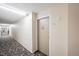 Hallway leading to an apartment door with an ornate door knocker at 350 S Clinton St # 8C, Denver, CO 80247