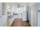 Kitchen with white cabinets, blue countertops, and wood-look flooring at 350 S Clinton St # 8C, Denver, CO 80247