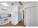 Kitchen with white appliances, ample cabinet space, and wood-look floors at 350 S Clinton St # 8C, Denver, CO 80247