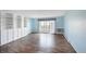 Light blue living room with sliding doors leading to the outdoor balcony and built-in shelves at 350 S Clinton St # 8C, Denver, CO 80247