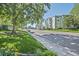 Street view of the condo building with green grass and mature trees at 350 S Clinton St # 8C, Denver, CO 80247