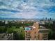 Rooftop pool atop brick high-rise in aerial view with city background at 1133 Race St # 8 & 9 B, Denver, CO 80206