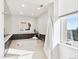 Bright bathroom with soaking tub, mosaic tile surround, and large window for natural light at 1133 Race St # 8 & 9 B, Denver, CO 80206