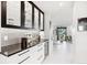 Hallway featuring a built-in bar with glass cabinets and a view into the sunroom at 1133 Race St # 8 & 9 B, Denver, CO 80206