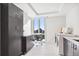 Bright laundry room with ample cabinet space, a front-loading washer and dryer, and a window view at 1133 Race St # 8 & 9 B, Denver, CO 80206