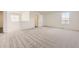 Spacious bedroom with neutral carpet, natural light from two windows and adjacent access to other rooms at 22014 E 39Th Ave, Aurora, CO 80019