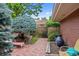 Landscaped backyard featuring a brick patio with seating, lush greenery, and a tranquil atmosphere at 2800 S University Blvd # 1, Denver, CO 80210