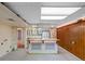 Basement featuring a wet bar, a small refrigerator, and a wood paneled wall at 2800 S University Blvd # 1, Denver, CO 80210