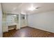 Finished basement area with built in desk/shelving unit and unique parquet wood-look flooring at 2800 S University Blvd # 1, Denver, CO 80210
