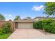 Attached two-car garage offers convenient parking and complements this home's brick exterior and landscaping at 2800 S University Blvd # 1, Denver, CO 80210