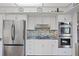 This kitchen features stainless steel appliances, double ovens, and colorful backsplash tiling at 2800 S University Blvd # 1, Denver, CO 80210