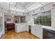 Bright kitchen features white cabinets, light countertops, and access to the adjacent living area at 2800 S University Blvd # 1, Denver, CO 80210