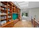 Inviting living area with custom wood bookshelves, a skylight, and a tranquil view of the outdoor pond at 2800 S University Blvd # 1, Denver, CO 80210