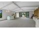 Bright living room boasts coffered ceilings, a fireplace, chandelier, and sliding doors to outdoor space at 2800 S University Blvd # 1, Denver, CO 80210
