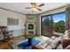 Cozy room featuring a brick fireplace, hardwood floors, an area rug, and sliding glass doors at 2800 S University Blvd # 1, Denver, CO 80210