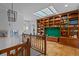 Upper view of a living room featuring custom wood bookshelves, a skylight, and elegant decor at 2800 S University Blvd # 1, Denver, CO 80210