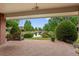 Inviting covered brick patio with a porch swing overlooks a serene pond surrounded by lush greenery at 2800 S University Blvd # 1, Denver, CO 80210