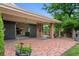 Charming covered patio with a brick floor and a porch swing, perfect for outdoor relaxation at 2800 S University Blvd # 1, Denver, CO 80210