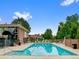 Community pool for residents, surrounded by lounge chairs and mature trees at 2800 S University Blvd # 1, Denver, CO 80210