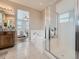 Bathroom with a bathtub and glass shower enclosure at 12953 Bridge View Ln, Parker, CO 80134