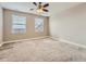 Bedroom with carpet, ceiling fan and large windows that bring in tons of natural light at 12953 Bridge View Ln, Parker, CO 80134