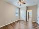 Bedroom with ceiling fan, closet, hardwood floors, neutral paint, and window at 12953 Bridge View Ln, Parker, CO 80134