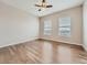 Bedroom featuring hardwood floors and a large window offering natural light at 12953 Bridge View Ln, Parker, CO 80134