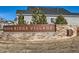 Stone sign with the community name 'Reata Ridge Village' on a landscaped plot at 12953 Bridge View Ln, Parker, CO 80134