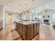 Elegant kitchen island with granite countertop, pendant lighting, and an open view to the living room at 12953 Bridge View Ln, Parker, CO 80134