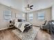 Bright main bedroom with a ceiling fan and hardwood flooring and cityscape view at 12953 Bridge View Ln, Parker, CO 80134