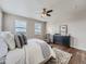 Main bedroom with a dresser, bed, and cityscape view at 12953 Bridge View Ln, Parker, CO 80134