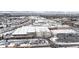 Aerial view of a shopping center and surrounding neighborhood in snowy conditions at 63 S Jackson St, Denver, CO 80209