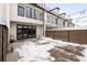 Private backyard patio with wood fence and string lights; some snow on ground at 63 S Jackson St, Denver, CO 80209