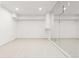 Clean, bright basement room with mirrored wall and light wood flooring at 63 S Jackson St, Denver, CO 80209